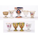 A group of nine egg cups: including a Chamberlains Worcester gilt and black decorated cup,
