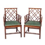 A pair of mahogany and green velvet upholstered Cockpen elbow chairs, in 18th century style,