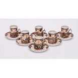 A set of six Royal Crown Derby silver-mounted porcelain coffee cans and saucers: decorated in an