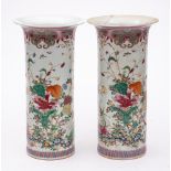 A pair of Chinese famille rose sleeve vases: each decorated overall with colourful flower sprays