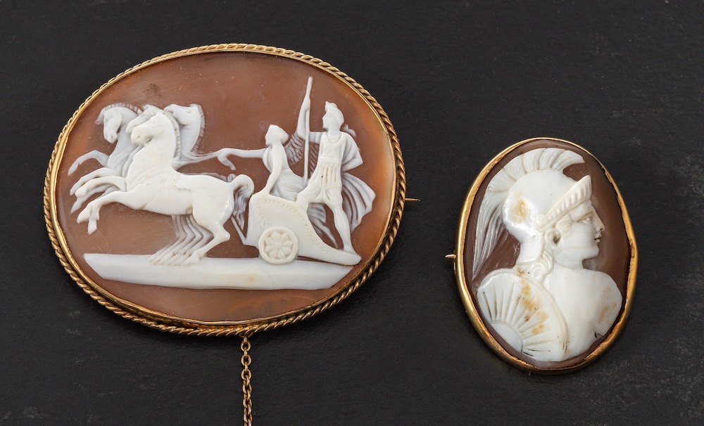 Two carved shell cameo brooches,: one depicting Mars in profile,