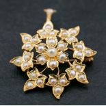 An 18ct gold, Victorian, seed pearl brooch/ pendant of stylised floral design,: length ca. 3.