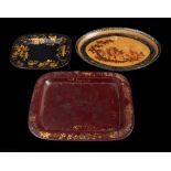 A 19th century tole ware oval tray: decorated with a village scene, 30.