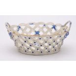 A First Period Worcester blue and white basket: of oval form with twig handles and applied with