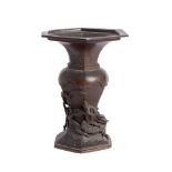 A Japanese bronze vase: with flared hexagonal rim, baluster body with entwined dragon,