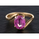 A synthetic pink sapphire ring,: stamped '750', length of ring head ca. 1.