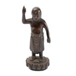 A bronze figure of a Buddha: standing on a lotus with arm raised, 14cm high.