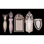 A collection of four assorted silver book marks,