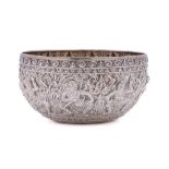 An Indian silver bowl: of circular outline, with embossed decoration of deities, 13cm diameter,