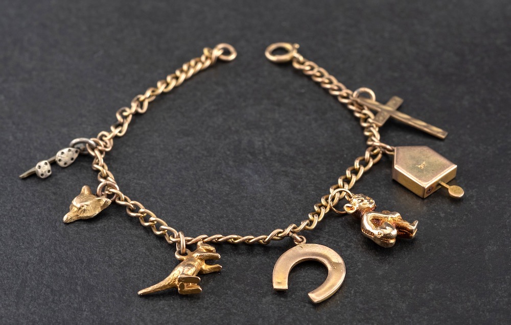 A curb-link charm bracelet and various charms,: the bracelet stamped '9CT',