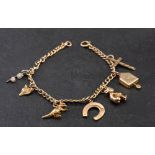A curb-link charm bracelet and various charms,: the bracelet stamped '9CT',