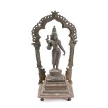 An Indian bronze standing figure of the goddess Menakshi of Madurai: holding a bird in her right