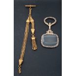 A late 19th century/ early 20th century gilt metal magnifying glass and watch chain,
