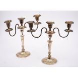 A pair of plated twin branch candelabra: with oval fluted sconces, on swept reeded branches,