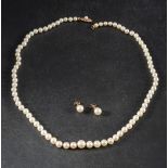 A Mikimoto graduated, cultured pearl necklace and pair of ear studs,