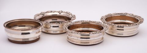 A pair of silver plated wine coasters: of circular outline with foliate borders,