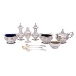 A collection of assorted silver condiments, various makers and dates: includes salts, pepperettes,