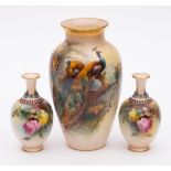 Three Royal Worcester porcelain vases: one of slender oviform painted by Reginald Austin with a
