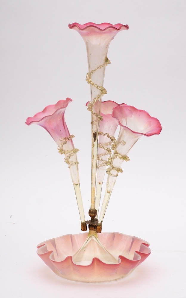 A pale green and pink tinged four branched epergne: the four trumpets with wavy rims and spiral