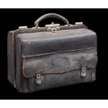 A late Victorian leather travelling vanity case: enclosing clear glass and silver mounted jars,