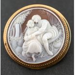 A 9ct gold shell cameo,: depicting a courting couple, hallmarks for Birmingham, 1987, length inc.