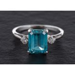 A step-cut blue topaz and round, brilliant-cut diamond three stone ring,