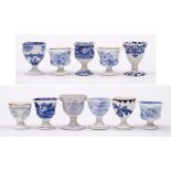 A group of eleven 19th Century blue and white transfer printed pottery and porcelain egg cups:,