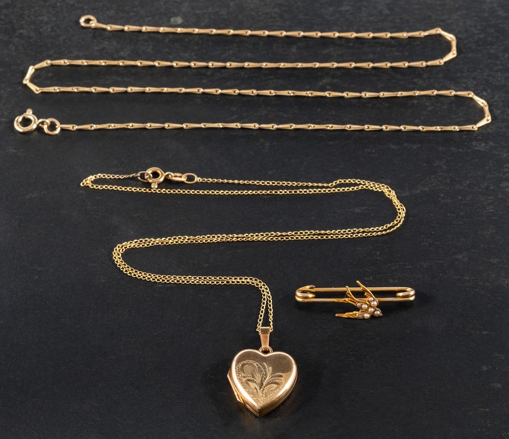 A locket, a brooch and two chains,