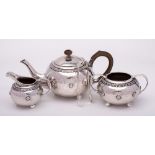 A George V hammered silver three-piece tea service, maker Liberty & Co, Birmingham,