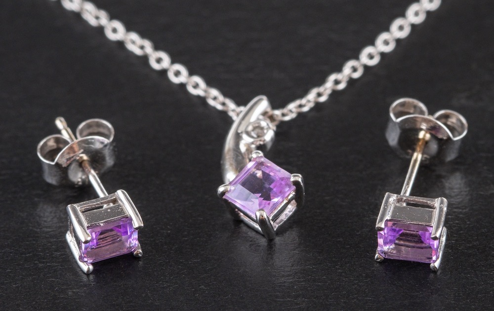 A pair of diamond ear studs, a pair of amethyst ear studs and an amethyst and diamond pendant,