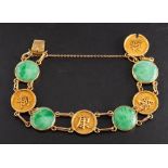 A mid-20th century, jade bracelet,: stamped '20', length ca. 17.5cm, total weight ca. 18.7gms.