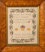 A George IV wool work sampler: with central verse, crowns and vase with shrubs,