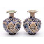 A pair of Doulton Lambeth vases: of globular form with raised flaring neck decorated with jewelled
