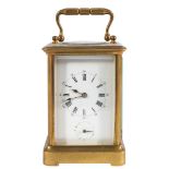 A Victorian French brass carriage alarm clock: the eight-day duration movement having a later