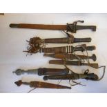 Eight assorted African and other daggers: most in leather sheaths.