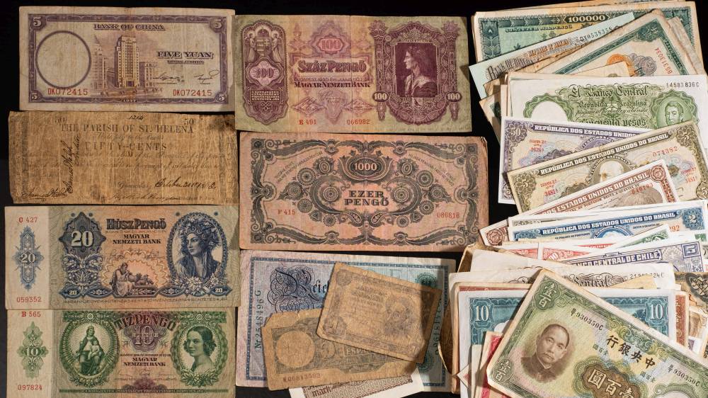 A collection of world banknotes including The Parish of St Helena Fifty Cents,