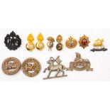 Five assorted plastic cap badges together with miscellaneous insignia.