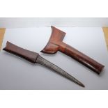 A late 19th/early 20th century kris: the slightly curved damascus blade with one piece hardwood