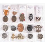 A collection of German badges and medals,: including two West Wall Medals, a SA party Rally badge,