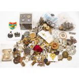 A quantity of assorted badges, belt buckles, buttons and assorted insignia.