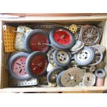 A case of assorted Meccano parts: including spars, spans, wheels and base plates.