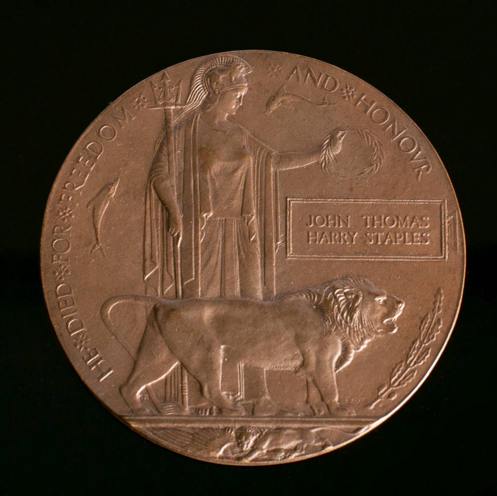 A WWI memorial plaque 'John Thomas Harry Staples' in card issue case.