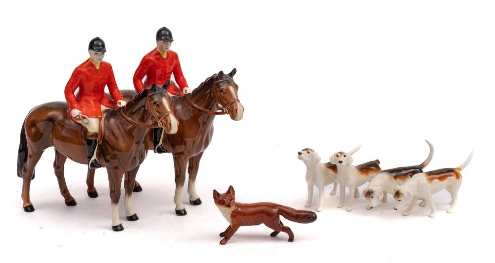 A Beswick hunting group: comprising two huntsmen on brown horses, a fox and three hounds,