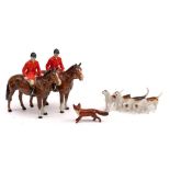A Beswick hunting group: comprising two huntsmen on brown horses, a fox and three hounds,