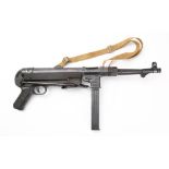 A reproduction Schmeisser MP40 sub machine gun: with folding stock and canvas sling.