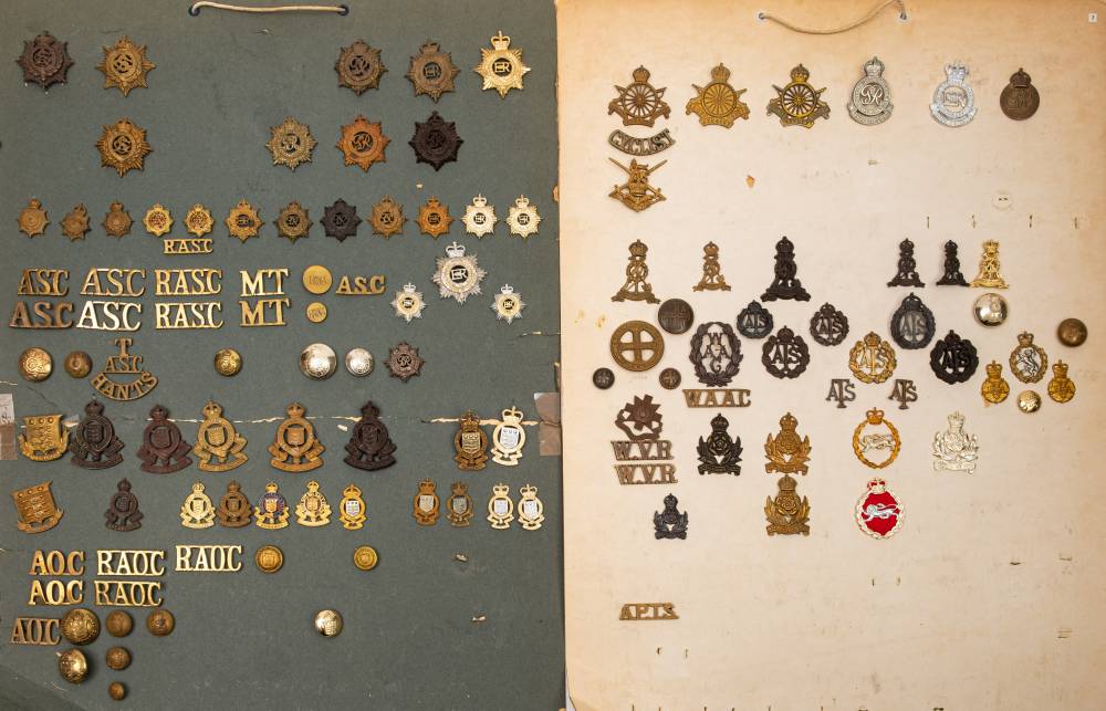 A collection of Corps and ATS cap badges, etc.