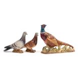 Three Beswick birds: comprising two pigeons, second version under blue and red gloss and a pheasant,