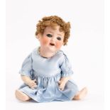 A Heubach Koppelsdorf bisque head doll: with applied wig over blue glass sleeping eyes,