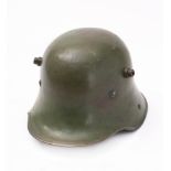 A German M1916 pattern Stahlhelm: stamped '60' to inner left side, with brown leather liner.