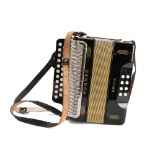 A Hohner Erica accordion: black with gilt banding in a hard shell case.